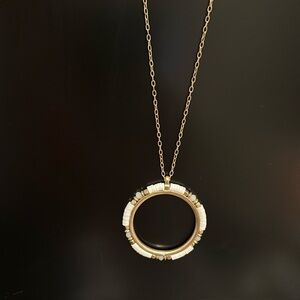 Nordstrom melrose and market gold tone necklace with white and gold pendant.